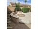 Cozy backyard featuring a stone fire pit and a relaxing seating area at 14380 W Monte Vista Rd, Goodyear, AZ 85395