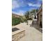 Beautiful backyard with a built-in BBQ area and a stylish stone fire pit at 14380 W Monte Vista Rd, Goodyear, AZ 85395