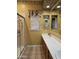 Bathroom features a glass shower, a mirror, and a sink at 14380 W Monte Vista Rd, Goodyear, AZ 85395