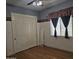 Bedroom with wood floors and a window with curtains at 14380 W Monte Vista Rd, Goodyear, AZ 85395