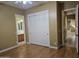 Bedroom featuring tan walls, wood floors, and a closet with sliding doors at 14380 W Monte Vista Rd, Goodyear, AZ 85395