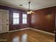 Bedroom with wood floors and two windows overlooking the yard at 14380 W Monte Vista Rd, Goodyear, AZ 85395