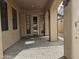 Spacious covered patio with brick flooring providing shade and access to the main house at 14380 W Monte Vista Rd, Goodyear, AZ 85395