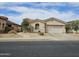 Inviting single-story home with a well-manicured front yard and desert landscaping at 14380 W Monte Vista Rd, Goodyear, AZ 85395