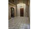 An elegant foyer showcasing a chandelier, tile flooring, and an arched entryway for a grand entrance at 14380 W Monte Vista Rd, Goodyear, AZ 85395