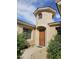 Welcoming front entrance with a charming turret and lush landscaping at 14380 W Monte Vista Rd, Goodyear, AZ 85395
