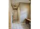 Bright hallway with tile flooring and bench seating leading to various rooms in the home at 14380 W Monte Vista Rd, Goodyear, AZ 85395