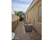 Paver side yard features A/C units and a palm tree creating an eye-catching landscape at 14380 W Monte Vista Rd, Goodyear, AZ 85395