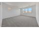 Spacious bedroom with neutral carpet, multiple windows offering natural light, and a serene atmosphere at 14789 W Lariat Ln, Surprise, AZ 85387