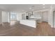 Open concept kitchen and living space with wood-look tile and lots of natural light at 14789 W Lariat Ln, Surprise, AZ 85387