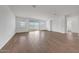 Bright living room with wood-look tile flooring and large sliding glass doors to the backyard at 14789 W Lariat Ln, Surprise, AZ 85387