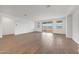 Spacious living room with wood-look tile flooring and large sliding glass doors to the backyard at 14789 W Lariat Ln, Surprise, AZ 85387