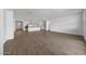 Open concept living area with wood-look tile, kitchen, and front entry at 14789 W Lariat Ln, Surprise, AZ 85387