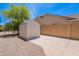 Backyard featuring a shed with a concrete slab surrounded by desert landscaping and a block wall at 1520 N Milly Pl, Casa Grande, AZ 85122