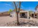 Backyard featuring a covered patio, low maintenance landscaping, and mature trees for shade at 1520 N Milly Pl, Casa Grande, AZ 85122