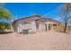 Back of home showing low-maintenance landscaping with a covered patio area at 1520 N Milly Pl, Casa Grande, AZ 85122