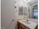 Well-lit bathroom featuring a vanity with a sink and a mirrored cabinet at 1520 N Milly Pl, Casa Grande, AZ 85122