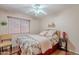 Inviting bedroom featuring a ceiling fan, laminate floors, and natural lighting at 1520 N Milly Pl, Casa Grande, AZ 85122