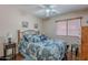 Comfortable bedroom with laminate flooring, natural light, and neutral wall color at 1520 N Milly Pl, Casa Grande, AZ 85122