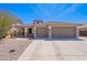 Charming home with stone accents, 3-car garage, and desert landscaping creates curb appeal at 1520 N Milly Pl, Casa Grande, AZ 85122