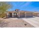 Charming single-story home with a desert landscape, a three-car garage and beautiful architecture at 1520 N Milly Pl, Casa Grande, AZ 85122