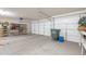 Spacious garage with ample storage space, including shelving and a large trash container at 1520 N Milly Pl, Casa Grande, AZ 85122