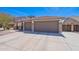 View of the home's garage, with three car spaces and a beautiful front yard at 1520 N Milly Pl, Casa Grande, AZ 85122
