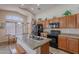 Well-lit kitchen features an island, modern appliances, and bright breakfast nook at 1520 N Milly Pl, Casa Grande, AZ 85122