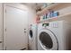 Practical laundry room with white washer and dryer and shelving for storage of supplies at 1520 N Milly Pl, Casa Grande, AZ 85122