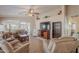 Spacious living room featuring comfortable furniture, a ceiling fan, and natural light at 1520 N Milly Pl, Casa Grande, AZ 85122