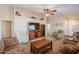 Cozy living room with ceiling fan, large TV, and comfortable seating at 1520 N Milly Pl, Casa Grande, AZ 85122