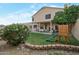 Spacious backyard with patio, green grass, and a playground at 15421 S 16Th Dr, Phoenix, AZ 85045