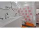 Bathroom features a double sink vanity, black hardware, and fun smiley face shower curtain at 15421 S 16Th Dr, Phoenix, AZ 85045