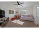 Bright bedroom features neutral walls, a ceiling fan, a daybed, and a window at 15421 S 16Th Dr, Phoenix, AZ 85045