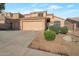 Charming two-story home featuring a three-car garage and low maintenance desert landscaping in a residential neighborhood at 15421 S 16Th Dr, Phoenix, AZ 85045