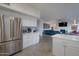 Modern kitchen with stainless steel appliances, eat-in dining area, and open floor plan into the living room at 15421 S 16Th Dr, Phoenix, AZ 85045