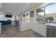 Modern kitchen with stainless steel appliances, large window and eat-in dining area open to the living room at 15421 S 16Th Dr, Phoenix, AZ 85045