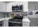 Bright kitchen features stainless steel appliances, marble backsplash, and ample counter space at 15421 S 16Th Dr, Phoenix, AZ 85045