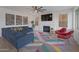 Spacious living room featuring modern decor, fireplace, and large windows for natural light at 15421 S 16Th Dr, Phoenix, AZ 85045
