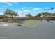 Community tennis court with lights and green surface at 15421 S 16Th Dr, Phoenix, AZ 85045