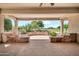 Spacious covered patio with golf course view, stone accents, and desert landscaping at 15534 W Big Sky Dr, Surprise, AZ 85374