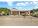 This home features a covered back patio and desert landscaping with rocks and native plants at 15534 W Big Sky Dr, Surprise, AZ 85374