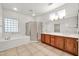 Bright primary bathroom with soaking tub, stand up shower, and dual vanity at 15534 W Big Sky Dr, Surprise, AZ 85374