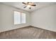 Bedroom with carpet flooring, a ceiling fan, and white blinds on the window at 15534 W Big Sky Dr, Surprise, AZ 85374