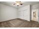 Bedroom featuring carpet flooring, a ceiling fan, and a double-door closet at 15534 W Big Sky Dr, Surprise, AZ 85374