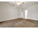 Bright bedroom with carpet, ceiling fan, and doorway to other rooms at 15534 W Big Sky Dr, Surprise, AZ 85374