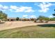 Scenic view of homes in a community surrounded by well-maintained landscaping and open spaces under a bright sky at 15534 W Big Sky Dr, Surprise, AZ 85374
