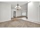 Bright dining room with chandelier, vaulted ceiling, and large window for natural light at 15534 W Big Sky Dr, Surprise, AZ 85374