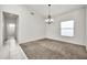 Dining room with neutral carpet, a chandelier and bright window at 15534 W Big Sky Dr, Surprise, AZ 85374