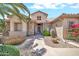 Beautiful home with desert landscaping including cacti, flowering bushes, stone accents, and a covered front porch at 15534 W Big Sky Dr, Surprise, AZ 85374